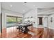 Spacious game room featuring pool table, hardwood floors, and view of the pool at 16804 Windsor Park Dr, Lutz, FL 33549