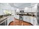 Bright kitchen featuring stainless steel appliances and granite countertops at 16804 Windsor Park Dr, Lutz, FL 33549