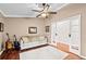 Cozy living room featuring hardwood floors, modern ceiling fan, and sliding french doors at 16804 Windsor Park Dr, Lutz, FL 33549