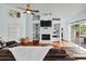 Cozy living room featuring a brick fireplace and an abundance of natural light at 16804 Windsor Park Dr, Lutz, FL 33549