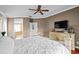 Spacious main bedroom with neutral tones, ceiling fan, and view of a luxurious ensuite bathroom at 16804 Windsor Park Dr, Lutz, FL 33549