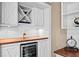 Close-up of home wet bar featuring wine storage, mini refrigerator and wood counter at 16804 Windsor Park Dr, Lutz, FL 33549