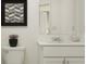 Cozy bathroom featuring a modern vanity, minimalist decor, and a stylish framed art piece at 208 27Th Se St, Ruskin, FL 33570