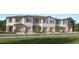 Charming townhouse exterior with individual garages and well-maintained landscaping at 208 27Th Se St, Ruskin, FL 33570