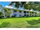 Beautiful condo complex with lush green lawn and mature trees at 2139 Elm St # 308, Dunedin, FL 34698
