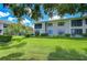 Beautifully landscaped backyard with lush green grass and mature trees, creating a serene outdoor space at 2139 Elm St # 308, Dunedin, FL 34698