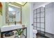 Modern bathroom with a sleek vanity, large mirror, and an adjacent glass-enclosed shower at 2139 Elm St # 308, Dunedin, FL 34698