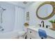 Bathroom featuring a classic bathtub, and a vanity with elegant oval mirror and décor at 2139 Elm St # 308, Dunedin, FL 34698