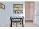 Bright dining area featuring open shelving, light countertops and a view through a pink entry way at 2139 Elm St # 308, Dunedin, FL 34698