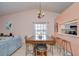 Dining table area with a view to the kitchen pass through featuring updated countertops in a neutral color scheme at 2139 Elm St # 308, Dunedin, FL 34698