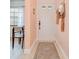 Inviting entryway with neutral tones, a decorative rug, and a view into the dining area at 2139 Elm St # 308, Dunedin, FL 34698
