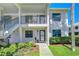 Two-story condo building with well-maintained landscaping, exterior stairs, and covered balconies at 2139 Elm St # 308, Dunedin, FL 34698