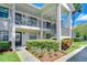 Well-maintained condo exterior with manicured landscaping, covered porch, and convenient access at 2139 Elm St # 308, Dunedin, FL 34698