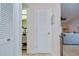 Hallway with white doors leading to bathroom and living area, offering seamless flow at 2139 Elm St # 308, Dunedin, FL 34698