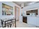 Bright kitchen featuring modern white cabinets, light countertops, and an adjacent dining area with a decorative built-in shelf at 2139 Elm St # 308, Dunedin, FL 34698