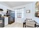 Cozy kitchen features updated appliances, bright lighting, dining table and exterior view at 2139 Elm St # 308, Dunedin, FL 34698