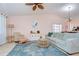 Inviting living room with a blue rug, comfortable seating, light wood floors, and a view towards the dining area and kitchen at 2139 Elm St # 308, Dunedin, FL 34698