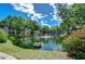 Scenic pond with a fountain surrounded by lush landscaping and community buildings at 2139 Elm St # 308, Dunedin, FL 34698
