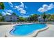 Community pool featuring a freeform design, surrounded by ample lounge chairs at 2139 Elm St # 308, Dunedin, FL 34698