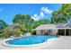 Community pool with ample seating and well-maintained pool house, perfect for relaxation and recreation at 2139 Elm St # 308, Dunedin, FL 34698