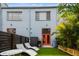 Cozy backyard featuring artificial turf, seating, grill, modern privacy fence, and tasteful landscaping at 2505 W Azeele St, Tampa, FL 33609