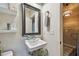 Cozy bathroom with a sink, mirror, open shelves, and stylish decor at 2505 W Azeele St, Tampa, FL 33609