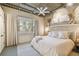 Bright bedroom features large window, comfortable bed, and modern ceiling fan at 2505 W Azeele St, Tampa, FL 33609