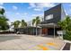 Modern condo exterior with covered parking, blue accent walls and vibrant orange doors at 2505 W Azeele St, Tampa, FL 33609