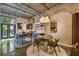 Open-concept eat-in kitchen featuring a long island, and dining space with modern decor and an industrial style at 2505 W Azeele St, Tampa, FL 33609