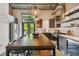 Modern kitchen features stainless appliances, dark wood cabinets, concrete block walls, and an island eating area at 2505 W Azeele St, Tampa, FL 33609