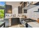Stylish kitchen with stainless steel appliances, dark wood cabinetry, and an island, creating a contemporary cooking space at 2505 W Azeele St, Tampa, FL 33609