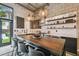 Modern kitchen with island seating, stainless steel appliances, and exposed brick, leading to outdoor area at 2505 W Azeele St, Tampa, FL 33609