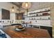 Stylish kitchen showcases a center island, floating shelves, stainless steel appliances, and sleek cabinetry at 2505 W Azeele St, Tampa, FL 33609