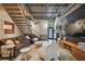 Stylish living room showcases exposed ductwork, a metal staircase, and modern furnishings and decor, with an open layout at 2505 W Azeele St, Tampa, FL 33609