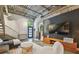 Modern living room boasts polished concrete floors, open ceiling, and stylish decor at 2505 W Azeele St, Tampa, FL 33609