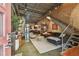 Spacious living room featuring exposed brick walls, metal staircase, polished concrete floors, and modern furnishings at 2505 W Azeele St, Tampa, FL 33609