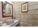 Chic powder room features a unique vessel sink and decorative mirror at 2505 W Azeele St, Tampa, FL 33609