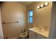 A bathroom with a toilet, a window, and a single sink vanity at 2713 W Chestnut St, Tampa, FL 33607