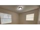 Bright bedroom featuring light, neutral walls, wood-look floors, and natural light at 2713 W Chestnut St, Tampa, FL 33607