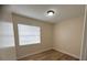 A bright bedroom boasts wood-look floors, neutral walls, a window, and a ceiling light at 2713 W Chestnut St, Tampa, FL 33607
