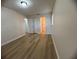 A bedroom featuring a wood-look floors, neutral walls, closet, and natural light at 2713 W Chestnut St, Tampa, FL 33607