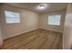 Bright bedroom featuring wood-look floors, neutral walls, and natural light at 2713 W Chestnut St, Tampa, FL 33607