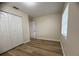 A bedroom featuring a closet, wood-look floors, neutral walls, and natural light at 2713 W Chestnut St, Tampa, FL 33607