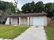 Front exterior showcasing a charming single story home, lawn, and driveway at 2713 W Chestnut St, Tampa, FL 33607