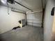 Garage featuring unfinished walls and floors, and a garage door at 2713 W Chestnut St, Tampa, FL 33607