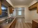 Bright kitchen area with classic cabinetry and stainless steel double sink at 2713 W Chestnut St, Tampa, FL 33607