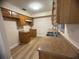 Traditional kitchen featuring wood cabinets, double sink, and new floors at 2713 W Chestnut St, Tampa, FL 33607