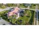 Aerial view of a well-maintained home with a sparkling screened-in pool and lush landscaping at 2886 Green Meadow Ct, Clearwater, FL 33761