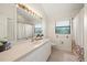 Well-lit bathroom featuring a large mirror, shower/tub combo, and ample counter space at 2886 Green Meadow Ct, Clearwater, FL 33761