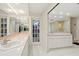 Bathroom featuring a large vanity with dual sinks and a glass block shower at 2886 Green Meadow Ct, Clearwater, FL 33761